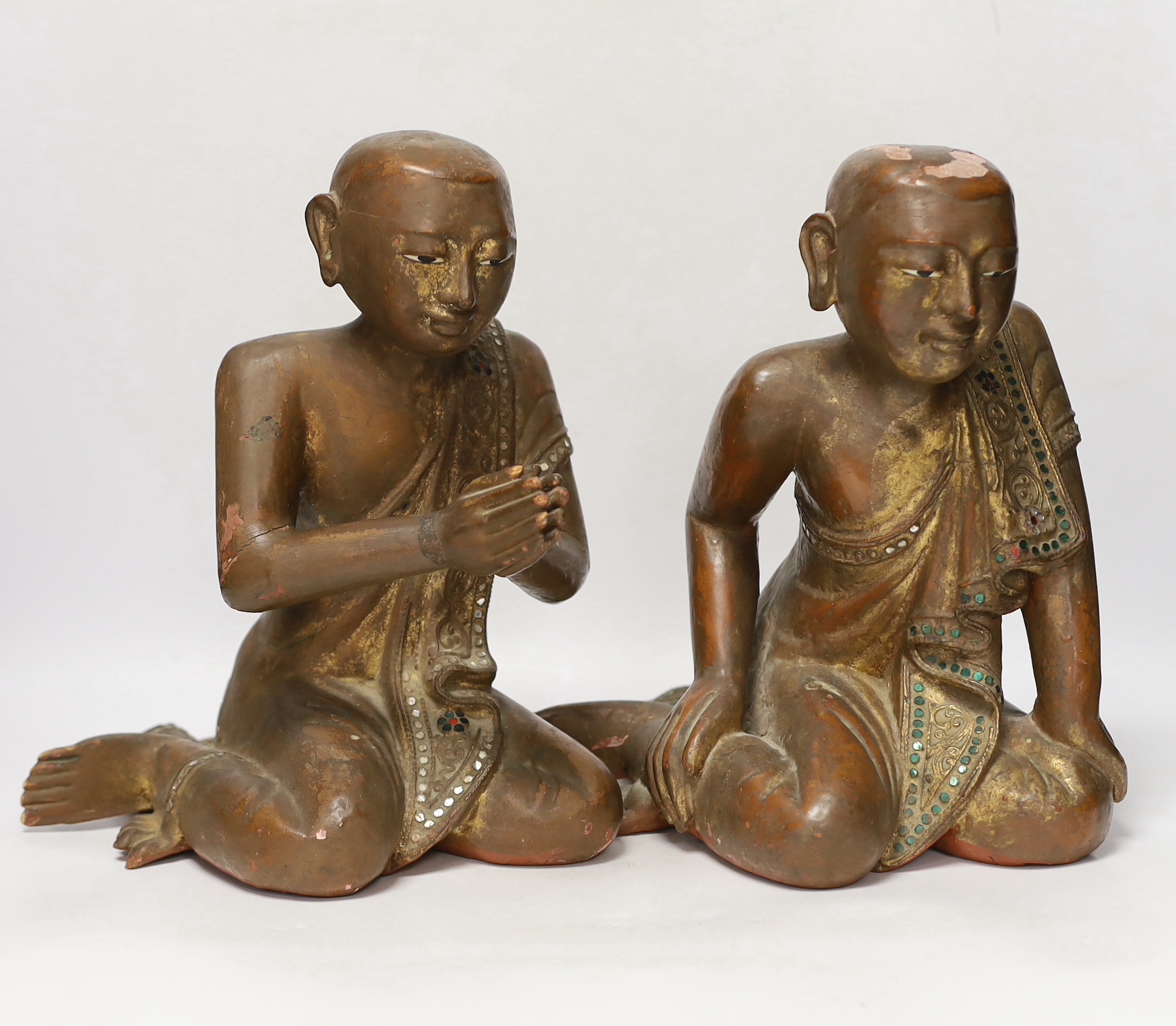 Two papier-mâché and lacquer Thai praying monks, 29.5cm high